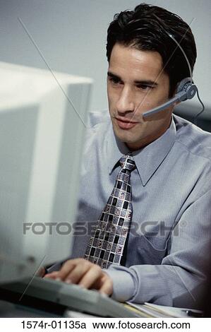 Stock Image - Male customer service representative wearing a headset. Fotosearch