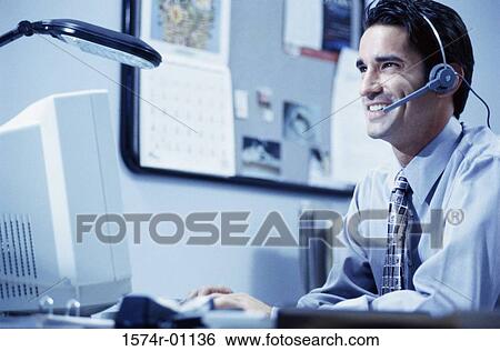 Stock Photograph - Male customer service representative wearing a headset. Fotosearch
