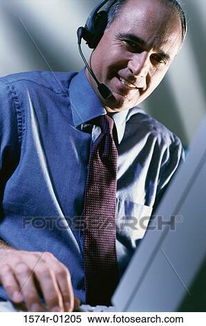 Male customer service representative wearing a headset View Large Photo Image Stock Photography - Male customer service representative wearing a headset. Fotosearch