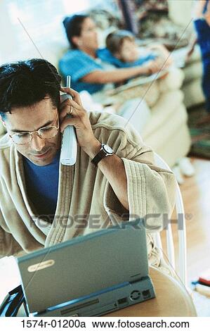 Stock Image - Man talking on a telephone. Fotosearch