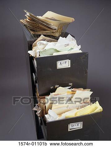 Stock Image - Overfilled file cabinet. Fotosearch