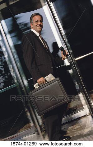 Portrait of a businessman standing at a doorway smiling View Large Photo Image Stock Photo - Portrait of a businessman standing at a doorway smiling. Fotosearch