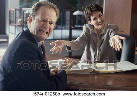 Stock Image - Portrait of a businesswoman and a businessman in an office. Fotosearch