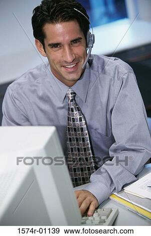 Stock Photo - Portrait of a male customer service representative wearing a headset. Fotosearch