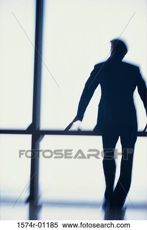 Stock Photography - Rear view of a businessman standing at a window. Fotosearch