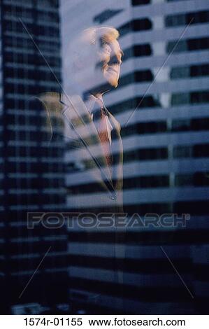 Stock Photography - Reflection of a businessman on a window. Fotosearch