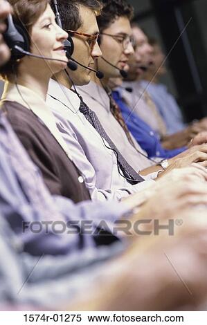 Stock Photography - Row of customer service representatives sitting in front of computer monitors. Fotosearch