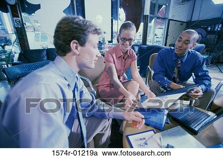 Three business executives discussing in an office View Large Photo Image Stock Image - Three business executives discussing in an office. Fotosearch