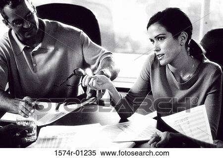 Stock Photography - Two business executives sitting in a meeting. Fotosearch