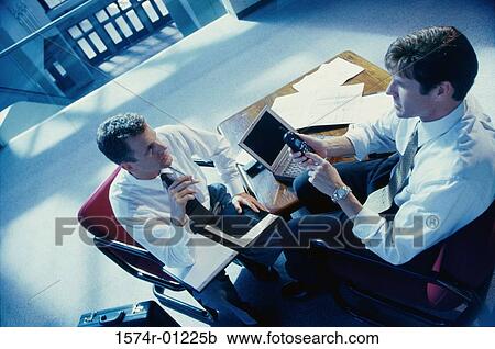 Two businessmen discussing View Large Photo Image Stock Image - Two businessmen discussing. Fotosearch