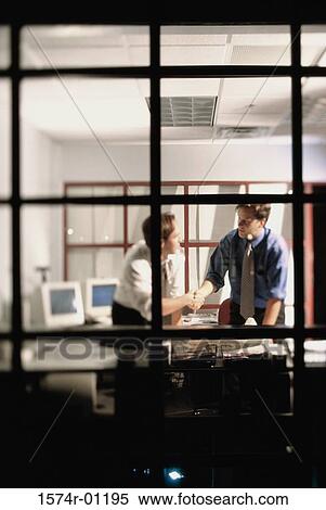 Two businessmen shaking hand in an office View Large Photo Image Stock Photography - Two businessmen shaking hand in an office. Fotosearch