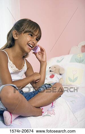 Close-up of a girl talking on a mobile phone View Large Photo Image Picture - Close-up of a girl talking on a mobile phone. Fotosearch