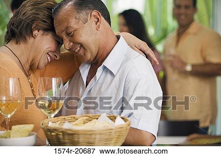 Close-up of a mature couple embracing each other and smiling View Large Photo Image Stock Photo - Close-up of a mature couple embracing each other and smiling. Fotosearch