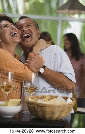 Close-up of a mature couple embracing each other and laughing View Large Photo Image Stock Photo - Close-up of a mature couple embracing each other and laughing. Fotosearch