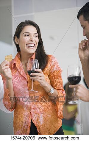 Close-up of a mature couple holding glasses of red wine and smiling View Large Photo Image Stock Photograph - Close-up of a mature couple holding glasses of red wine and smiling. Fotosearch