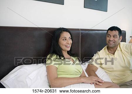 Close-up of a mature couple reclining in the bed and smiling View Large Photo Image Stock Image - Close-up of a mature couple reclining in the bed and smiling. Fotosearch