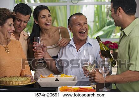 Close-up of a mature couple with his friends enjoying a party View Large Photo Image Stock Image - Close-up of a mature couple with his friends enjoying a party. Fotosearch