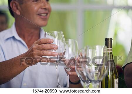 Close-up of a mature man holding wineglasses View Large Photo Image Stock Image - Close-up of a mature man holding wineglasses. Fotosearch