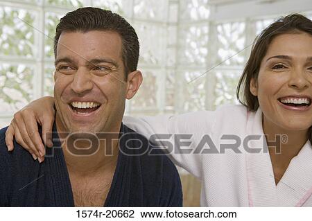 Stock Image - Close-up of a mid adult couple smiling. Fotosearch