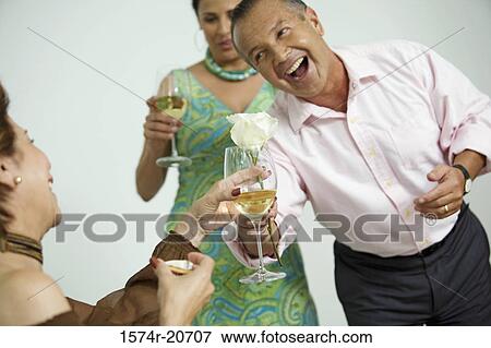 Mature man giving a flower to a mature woman with another mature woman standing behind him View Large Photo Image Stock Photo - Mature man giving a flower to a mature woman with another mature woman standing behind him. Fotosearch