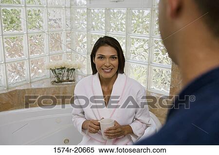 Mid adult woman looking at a mid adult man in the bathroom View Large Photo Image Stock Photography - Mid adult woman looking at a mid adult man in the bathroom. Fotosearch