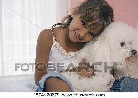 Portrait of a girl hugging her dog and smiling View Large Photo Image Stock Photo - Portrait of a girl hugging her dog and smiling. Fotosearch