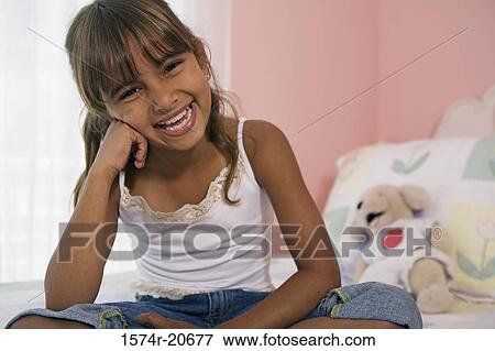 Portrait of a girl sitting in the bed and smiling View Large Photo Image Stock Photo - Portrait of a girl sitting in the bed and smiling. Fotosearch