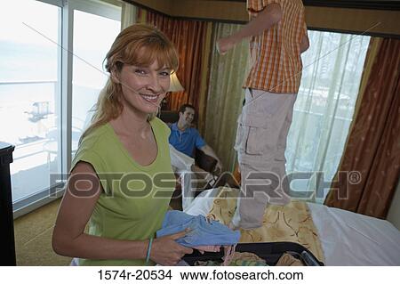 Portrait of a young woman holding clothes and smiling View Large Photo Image Picture - Portrait of a young woman holding clothes and smiling. Fotosearch