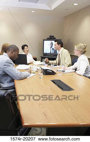 Business executives talking in a video conference room View Large Photo Image Stock Photo - Business executives talking in a video conference room. Fotosearch