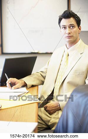Businessman sitting in an office View Large Photo Image Picture - Businessman sitting in an office. Fotosearch