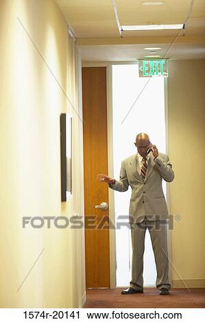 Businessman talking on a mobile phone View Large Photo Image Stock Image - Businessman talking on a mobile phone. Fotosearch