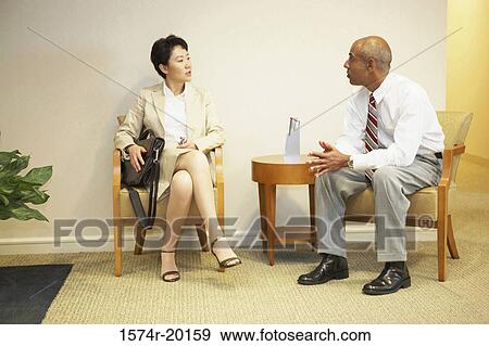 Businessman talking to a businesswoman View Large Photo Image Stock Photo - Businessman talking to a businesswoman. Fotosearch