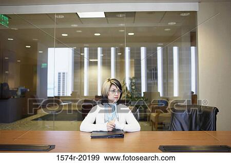 Stock Photo - Businesswoman sitting in an office. Fotosearch