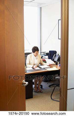 Businesswoman working in an office View Large Photo Image Stock Image - Businesswoman working in an office. Fotosearch