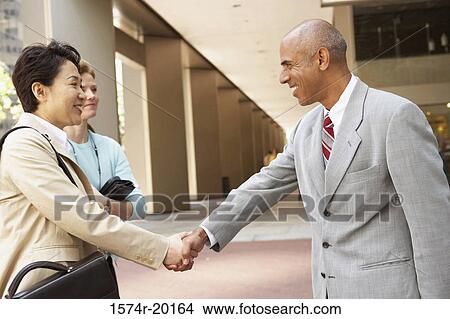 Close-up of a businessman and a businesswoman shaking hands View Large Photo Image Picture - Close-up of a businessman and a businesswoman shaking hands. Fotosearch