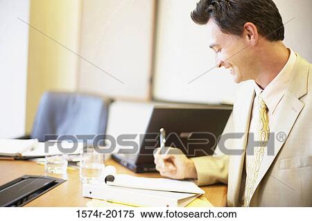 Close-up of a businessman holding a pen and smiling View Large Photo Image Stock Photography - Close-up of a businessman holding a pen and smiling. Fotosearch