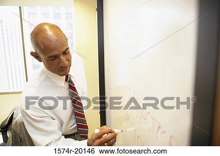 Close-up of a businessman writing with a marker on a white board View Large Photo Image Stock Photograph - Close-up of a businessman writing with a marker on a white board. Fotosearch