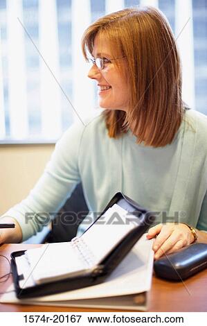 Close-up of a businesswoman smiling in an office View Large Photo Image Stock Photo - Close-up of a businesswoman smiling in an office. Fotosearch