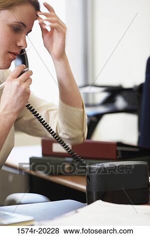 Close-up of a businesswoman talking on the telephone in an office View Large Photo Image Stock Photo - Close-up of a businesswoman talking on the telephone in an office. Fotosearch