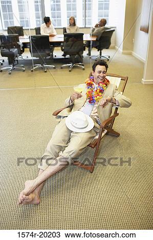 High angle view of a businessman relaxing in an office View Large Photo Image Stock Image - High angle view of a businessman relaxing in an office. Fotosearch