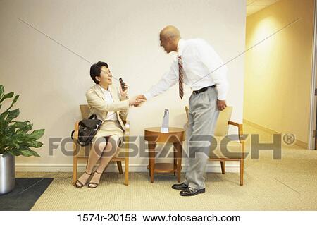 Side profile of a businessman and a businesswoman shaking hands View Large Photo Image Stock Photo - Side profile of a businessman and a businesswoman shaking hands. Fotosearch