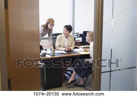 Three businesswomen talking in an office View Large Photo Image Stock Photography - Three businesswomen talking in an office. Fotosearch
