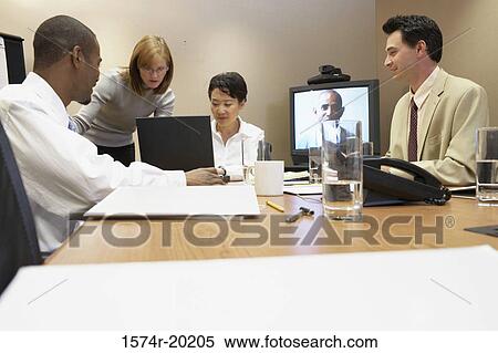 Two businessmen and two businesswomen in a video conference View Large Photo Image Stock Photography - Two businessmen and two businesswomen in a video conference. Fotosearch