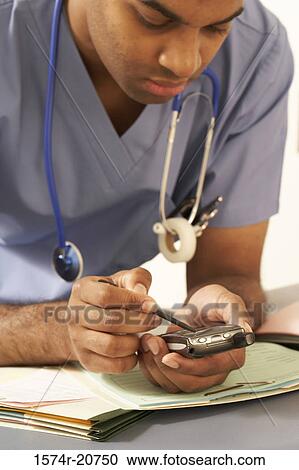 Close-up of a male doctor using a PDA View Large Photo Image Stock Image - Close-up of a male doctor using a PDA. Fotosearch