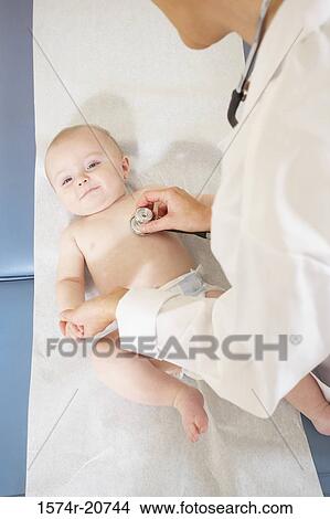 High angle view of a female doctor examining a baby boy with a stethoscope View Large Photo Image Picture - High angle view of a female doctor examining a baby boy with a stethoscope. Fotosearch