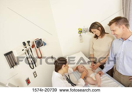 High angle view of a female doctor examining a baby boy View Large Photo Image Stock Photo - High angle view of a female doctor examining a baby boy. Fotosearch