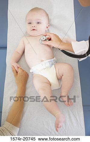 Stock Photography - High angle view of a female doctor examining a baby boy with a stethoscope. Fotosearch