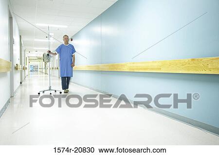 Male patient walking with an IV drip stand View Large Photo Image Stock Image - Male patient walking with an IV drip stand. Fotosearch