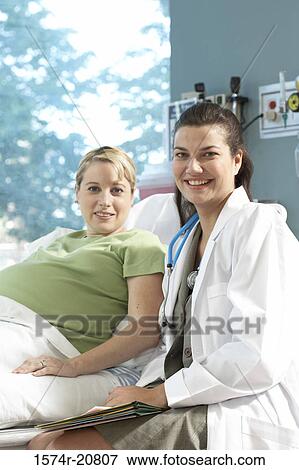 Stock Photo - Portrait of a female doctor and a pregnant woman smiling. Fotosearch