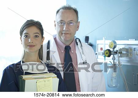Portrait of a female nurse and a male doctor smiling View Large Photo Image Picture - Portrait of a female nurse and a male doctor smiling. Fotosearch
